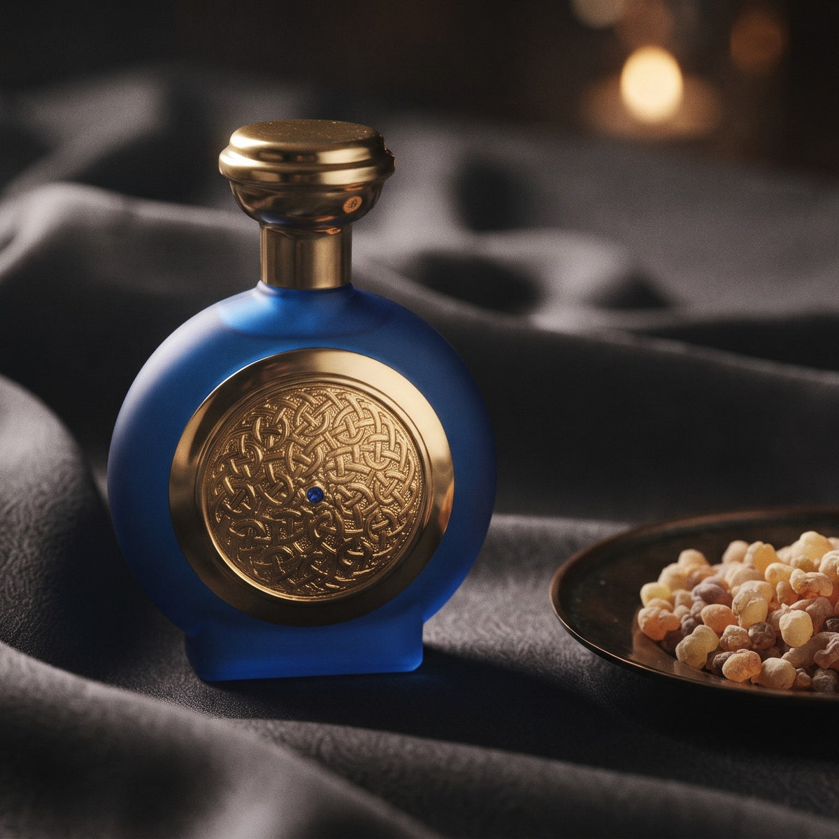 Boadicea the Victorious Blue Sapphire EDP on charcoal silk with frankincense resin granules in a small saucer
