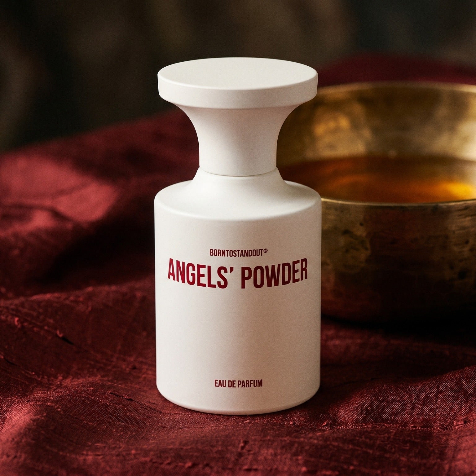 Borntostandout Angels EDP on russet silk with a matte brass bowl holding tonka and amber pieces