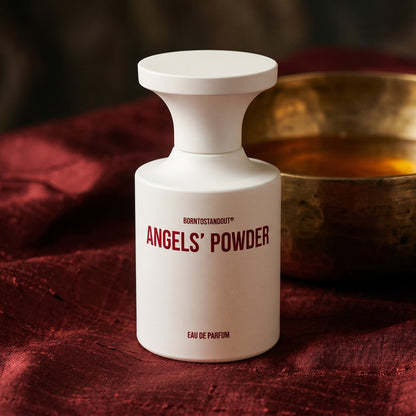 Borntostandout Angels EDP on russet silk with a matte brass bowl holding tonka and amber pieces