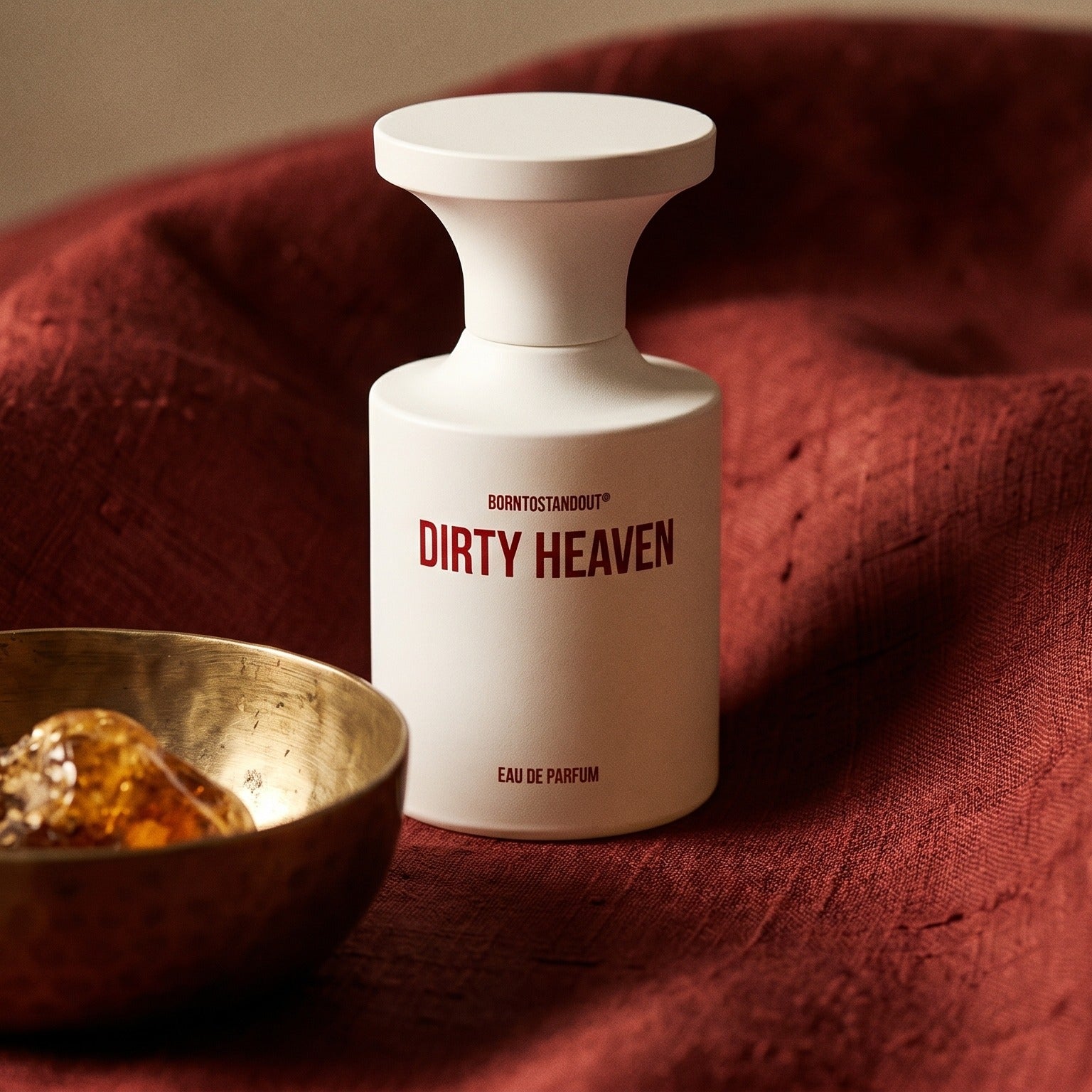 Borntostandout Dirty Heaven EDP on deep caramel velvet with a small copper jar of resin balm
