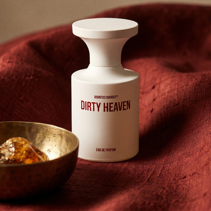 Borntostandout Dirty Heaven EDP on deep caramel velvet with a small copper jar of resin balm