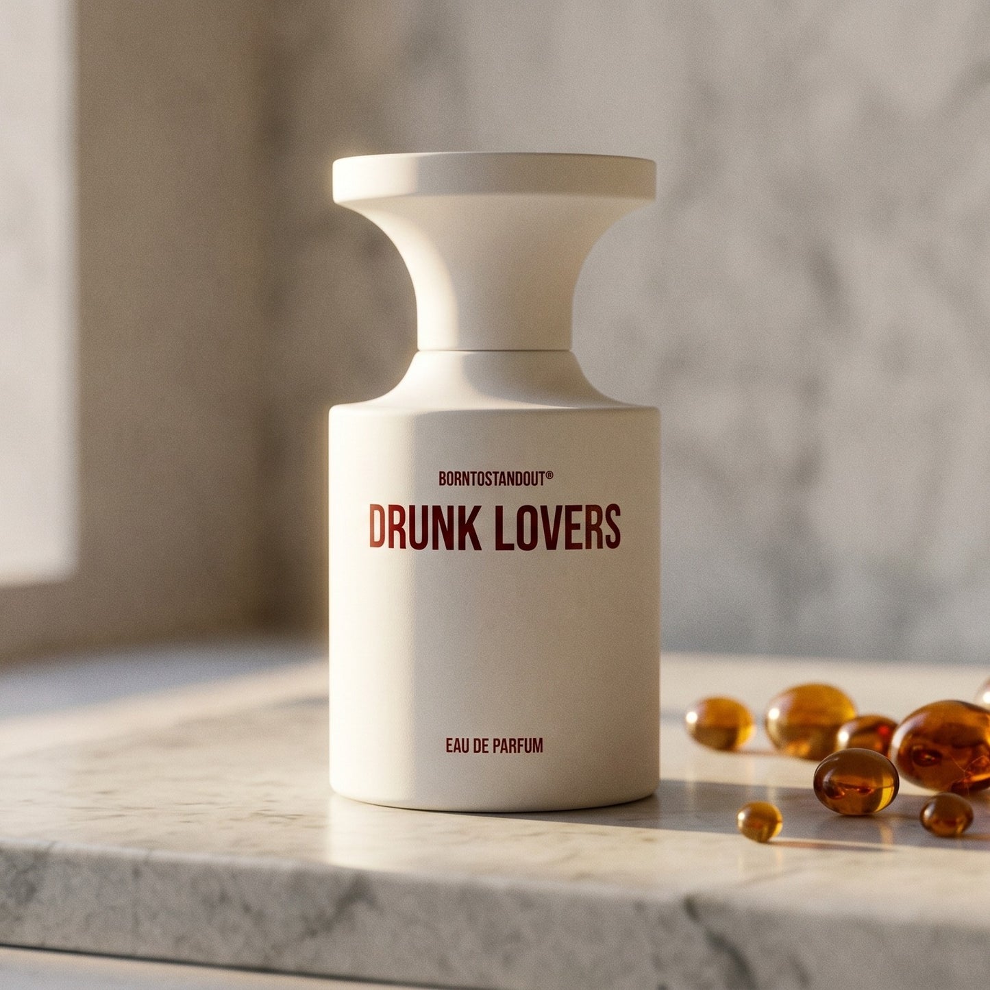 Borntostandout Drunk Lovers EDP on polished limestone with benzoin resin pebbles arranged loosely