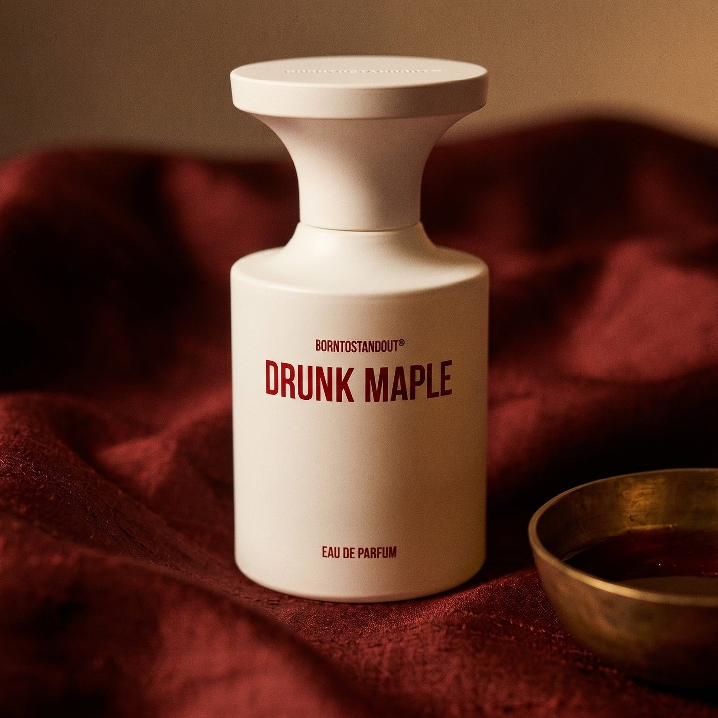 Borntostandout Drunk Maple EDP on raw silk of oxblood color with a brass bowl of ambergris tincture
