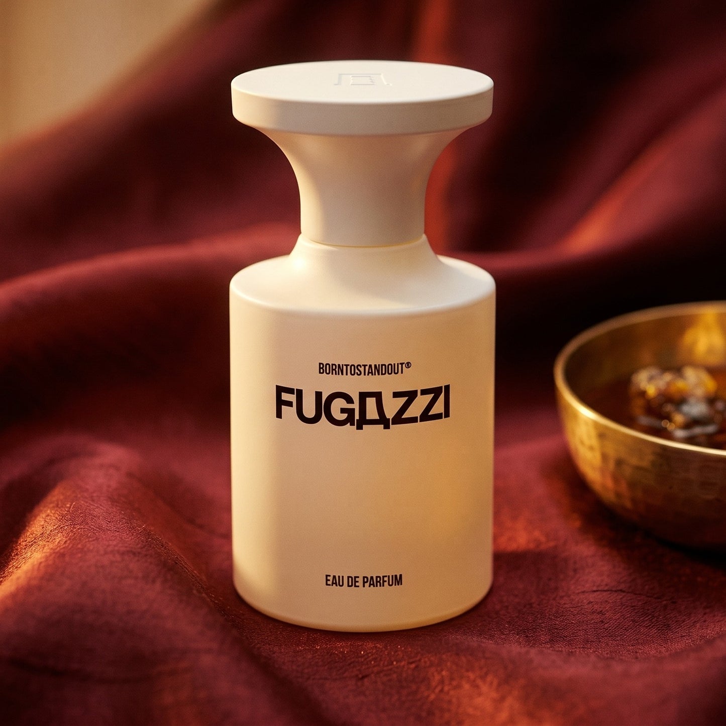 Borntostandout Fugazzi By EDP on russet silk with a matte brass bowl holding tonka and amber pieces