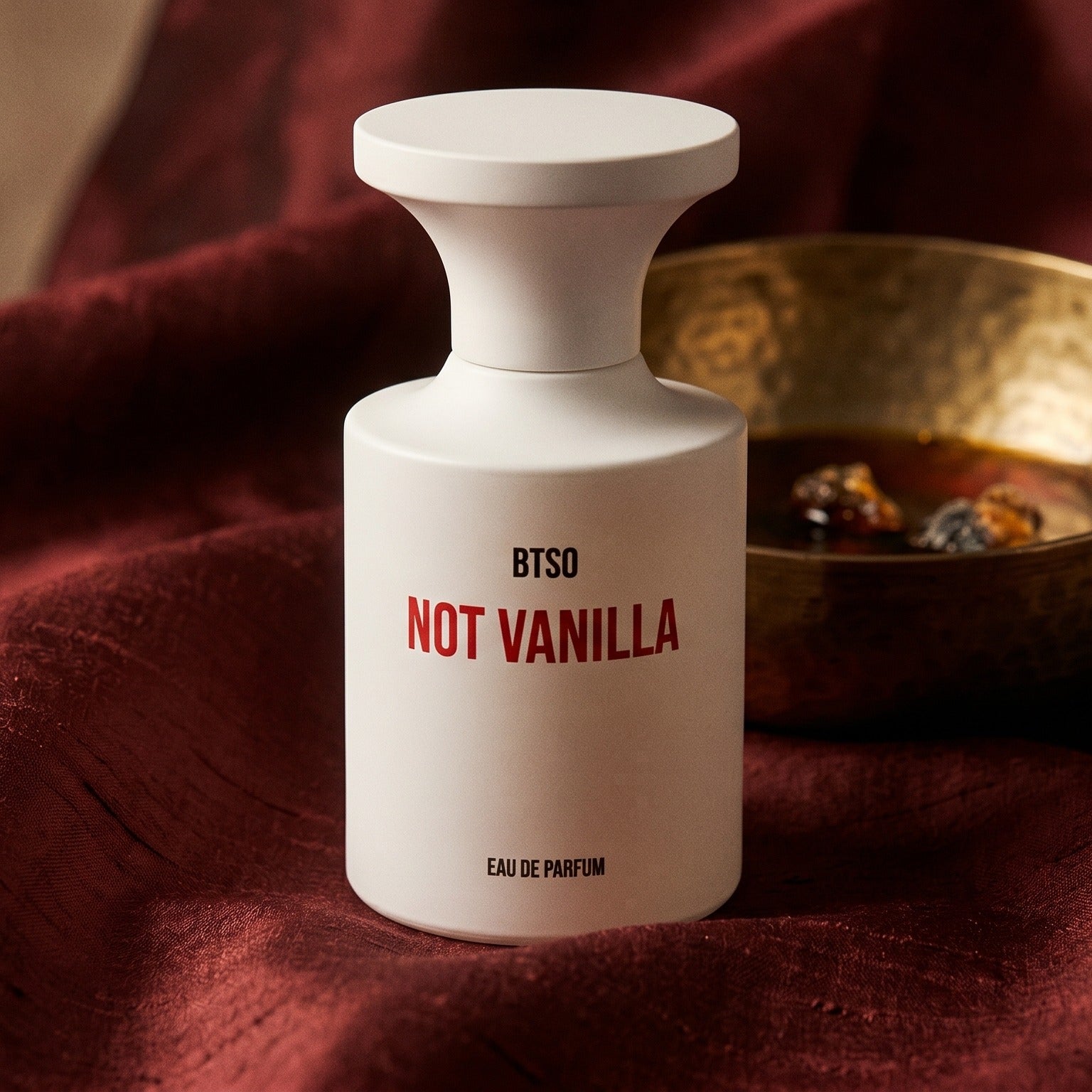 Borntostandout Not Vanilla EDP on raw silk of oxblood color with a brass bowl of ambergris tincture