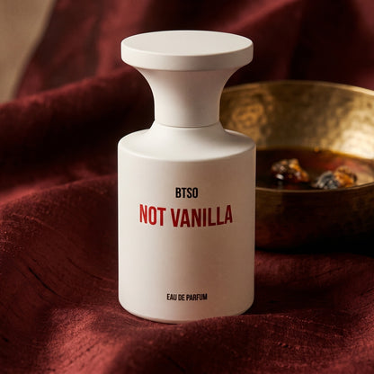 Borntostandout Not Vanilla EDP on raw silk of oxblood color with a brass bowl of ambergris tincture