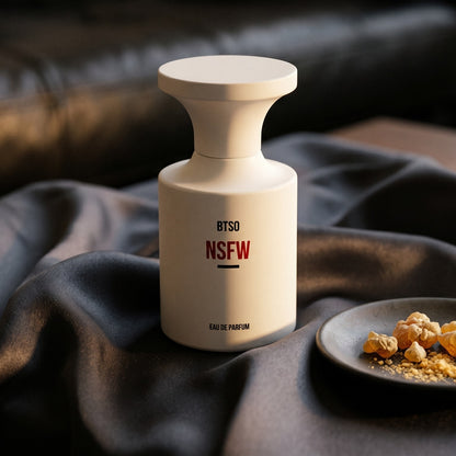 Borntostandout NSFW EDP on burnt-orange silk with smoldering agarwood on a stone dish
