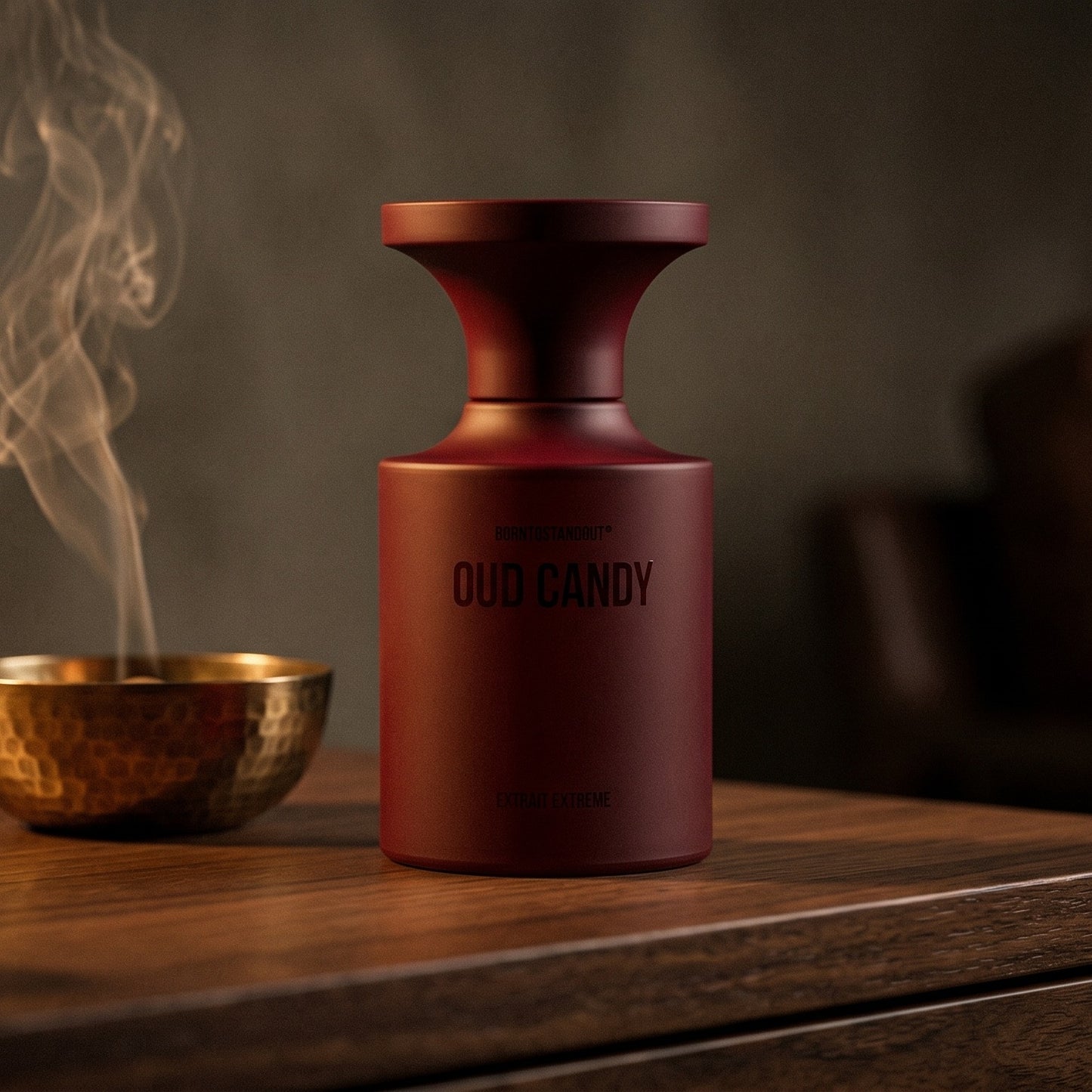 Borntostandout Oud Candy Extrait Extreme on aged walnut board with dried agarwood shavings scattered loosely