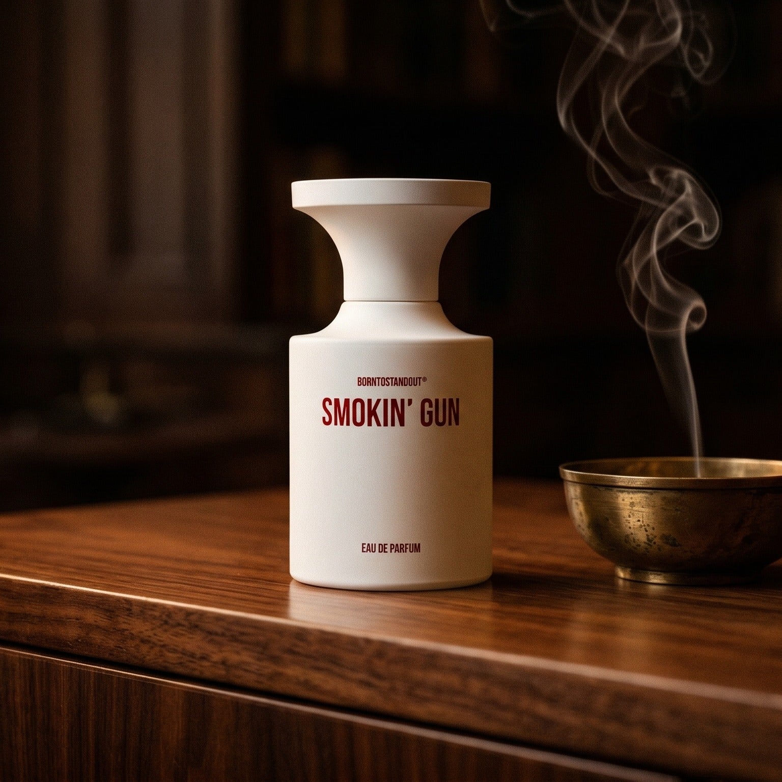 Borntostandout Smokin Gun EDP on ebony surface with a hammered copper censer releasing frankincense haze