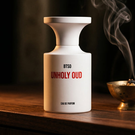Borntostandout Unholy Oud EDP on ebony surface with a hammered copper censer releasing frankincense haze