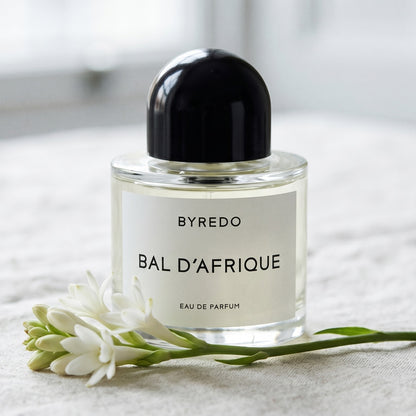 Byredo Bal'd Afrique on pale muslin with a spray of osmanthus and jasmine petals