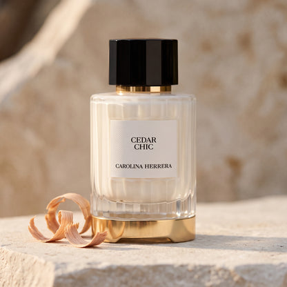 Carolina Herrera Cedar Chic EDP on pale stone with a few curls of cedar shavings