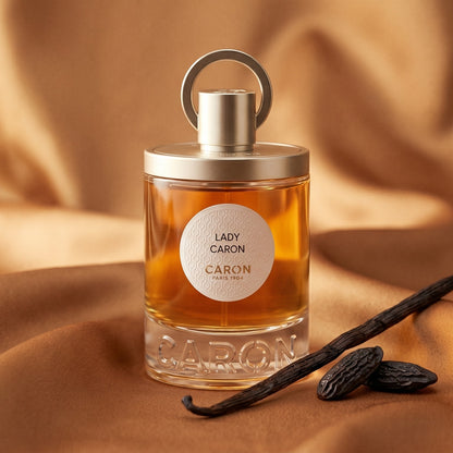Caron Lady Caron EDP on golden silk with a small dish of crystallized honey