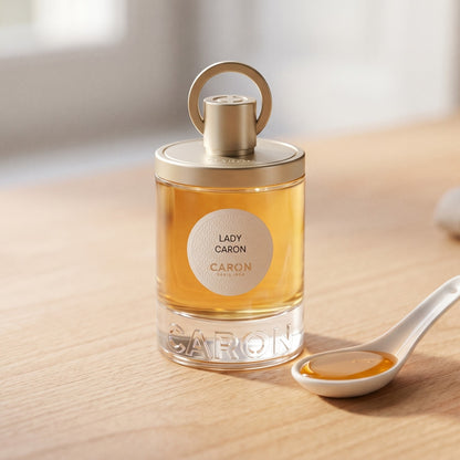 Caron Lady Caron EDP on ivory-stained wood with a small bowl of crystallized ginger