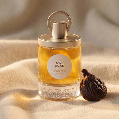 Caron Lady Caron EDP on ivory cashmere with a small cluster of spiced walnuts
