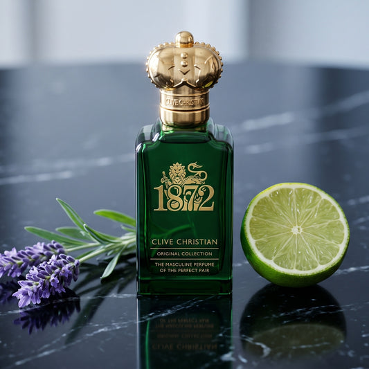 Clive Christian 1872 Masculin on black marble with a sprig of lavender and a halved lime