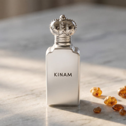 Clive Christian Kinam Parfum - Dubai Exclusive on pale grey marble with amber resin beads scattered to one side