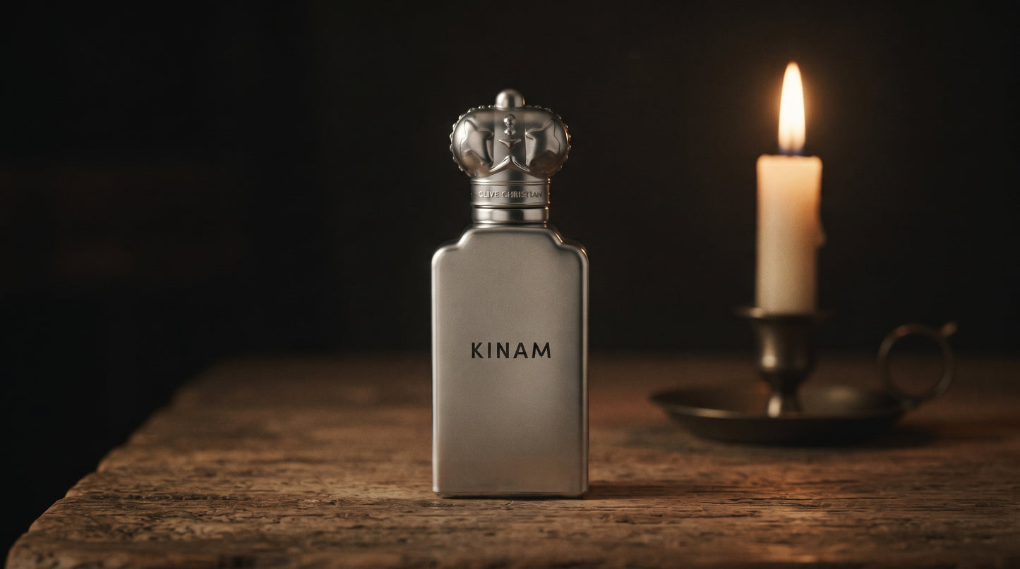Clive Christian Kinam Parfum - Dubai Exclusive on aged teak with a candle burning gently to frame-right