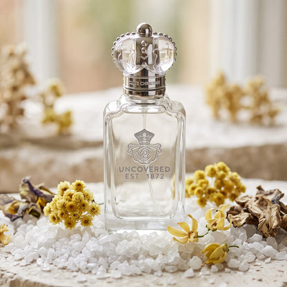 Clive Christian Uncovered on white sea salt crystals on pale stone with immortelle, iris and ylang ylang