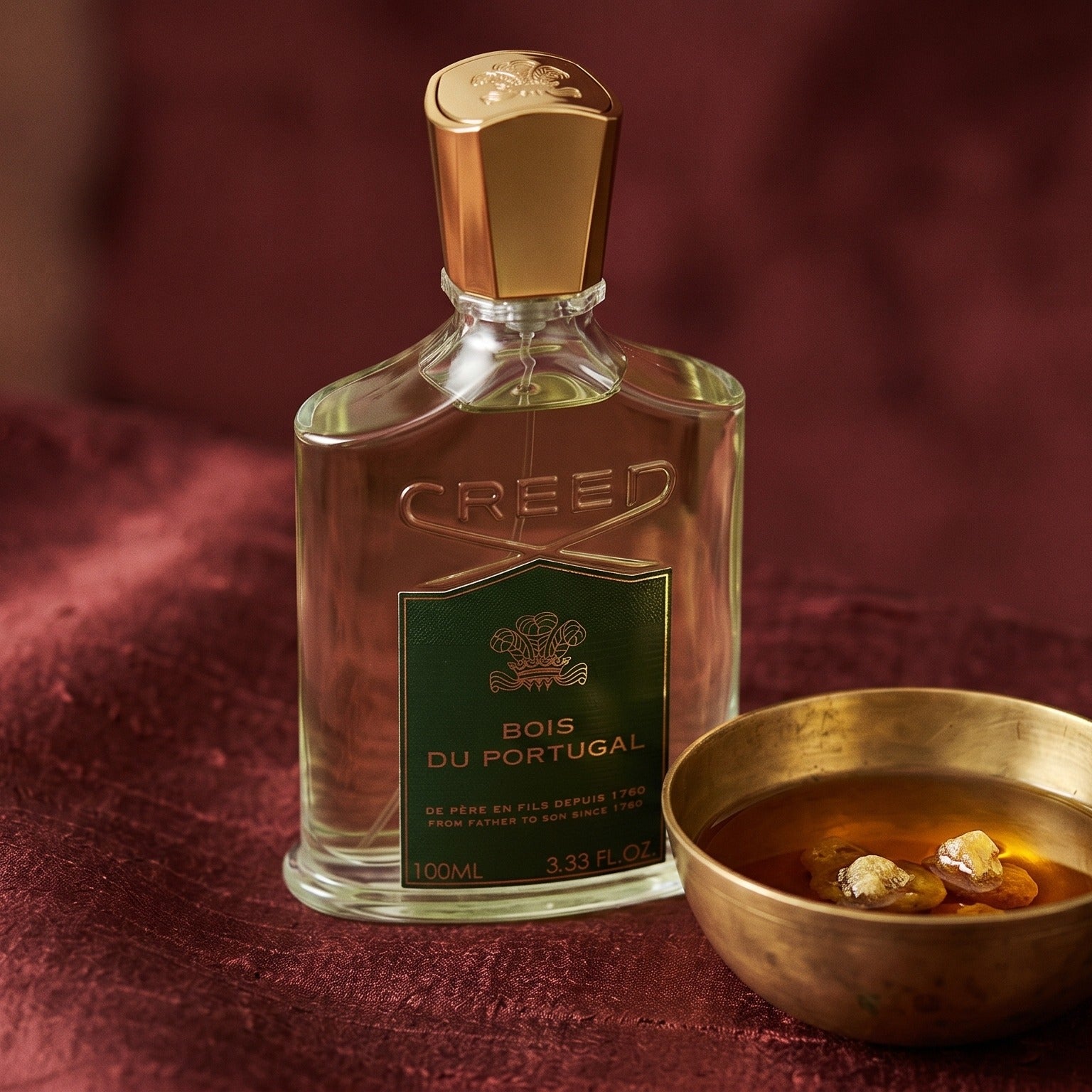 Creed Bois de Portugal on cinnamon-tone silk with a shallow saucer of warm benzoin resin