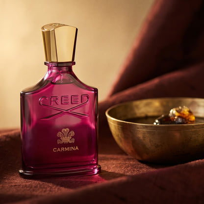 Creed Carmina on cinnamon-tone silk with a shallow saucer of warm benzoin resin
