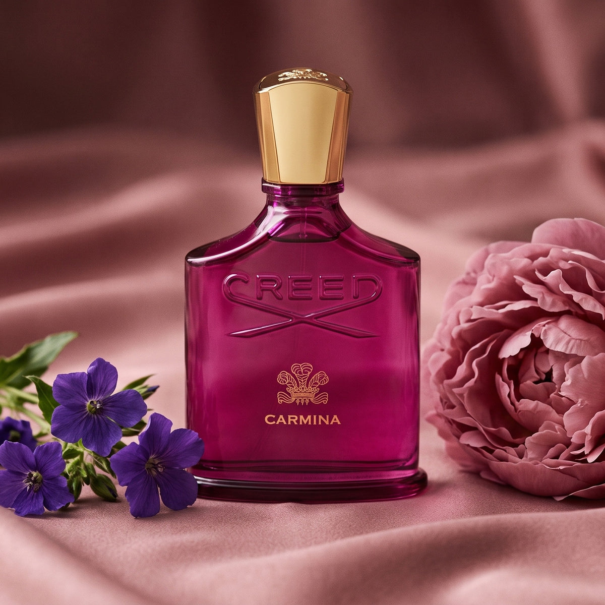 Creed Carmina on dusty rose silk with a single peony beside a few violets
