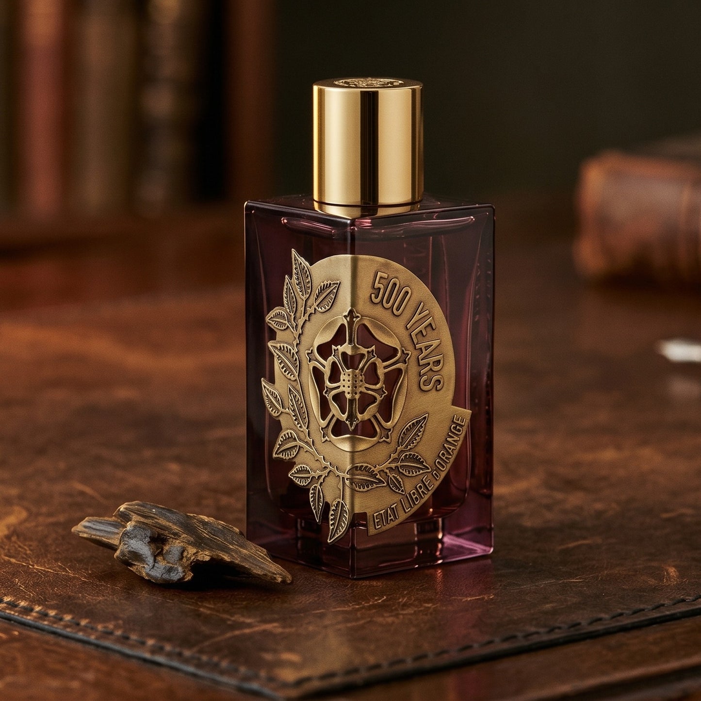 Etat Libre 500 Year EDP on patinated leather tray with a pinch of frankincense beside the bottle