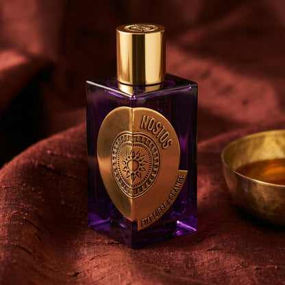 Etat Libre Nostos on raw silk of oxblood color with a brass bowl of ambergris tincture