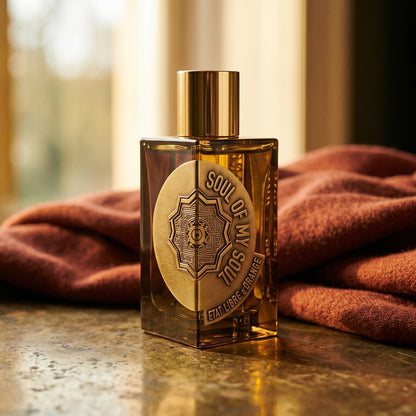 Etat Libre Soul of My Soul on aged brass tray with a folded pashmina in rust tone