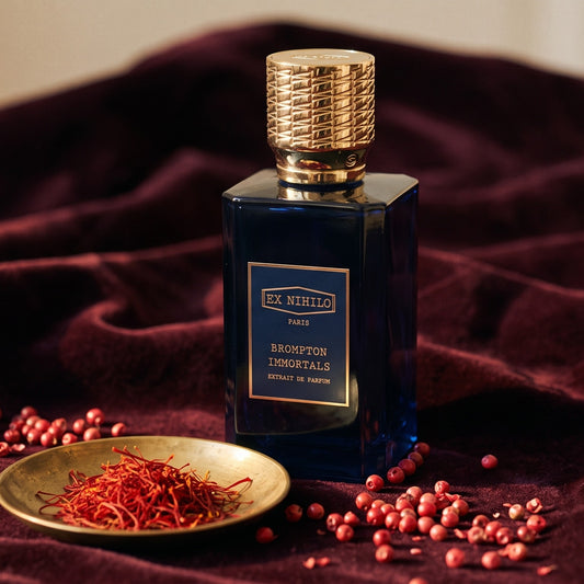 Ex Nihilo Brompton Immortals Extrait de Parfum on dark burgundy velvet with saffron threads and pink peppercorns
