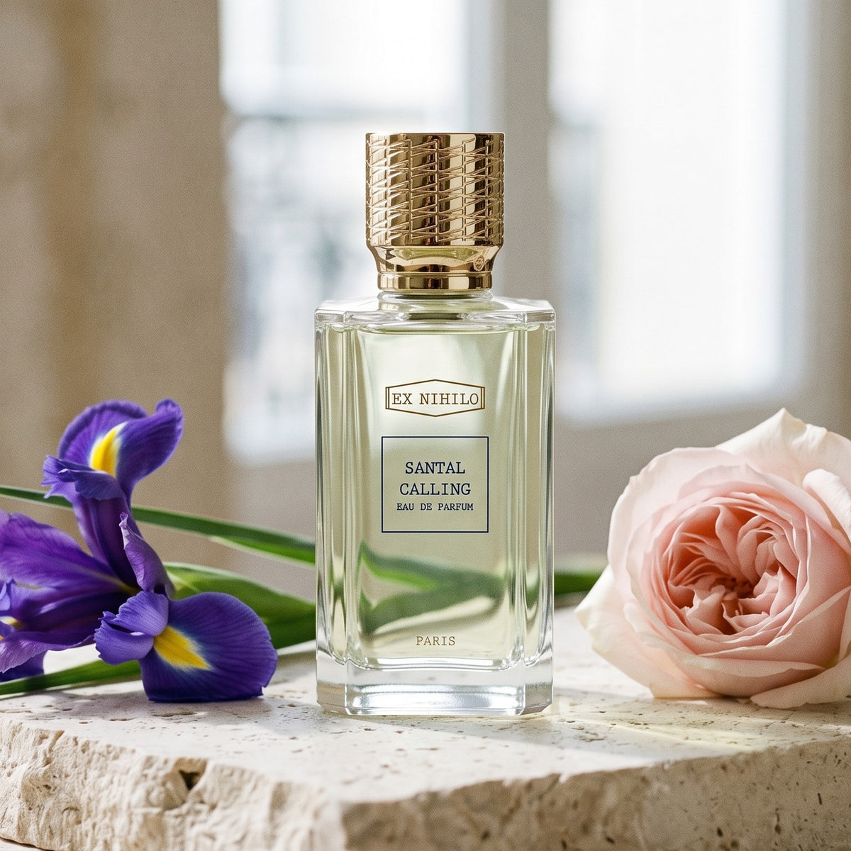 Ex Nihilo Santal Calling EDP on pale limestone with iris and a pale rose