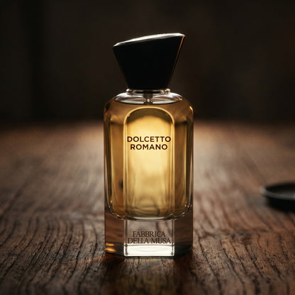 Fabbrica Della Musa Dolcetto Romano EDP on dark cherrywood with a tall beeswax taper casting warm light