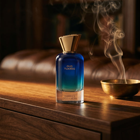Fabbrica Della Musa Oud Tuareg Extrait de Parfum on black marble with a tall brass incense holder, smoke trailing diagonally