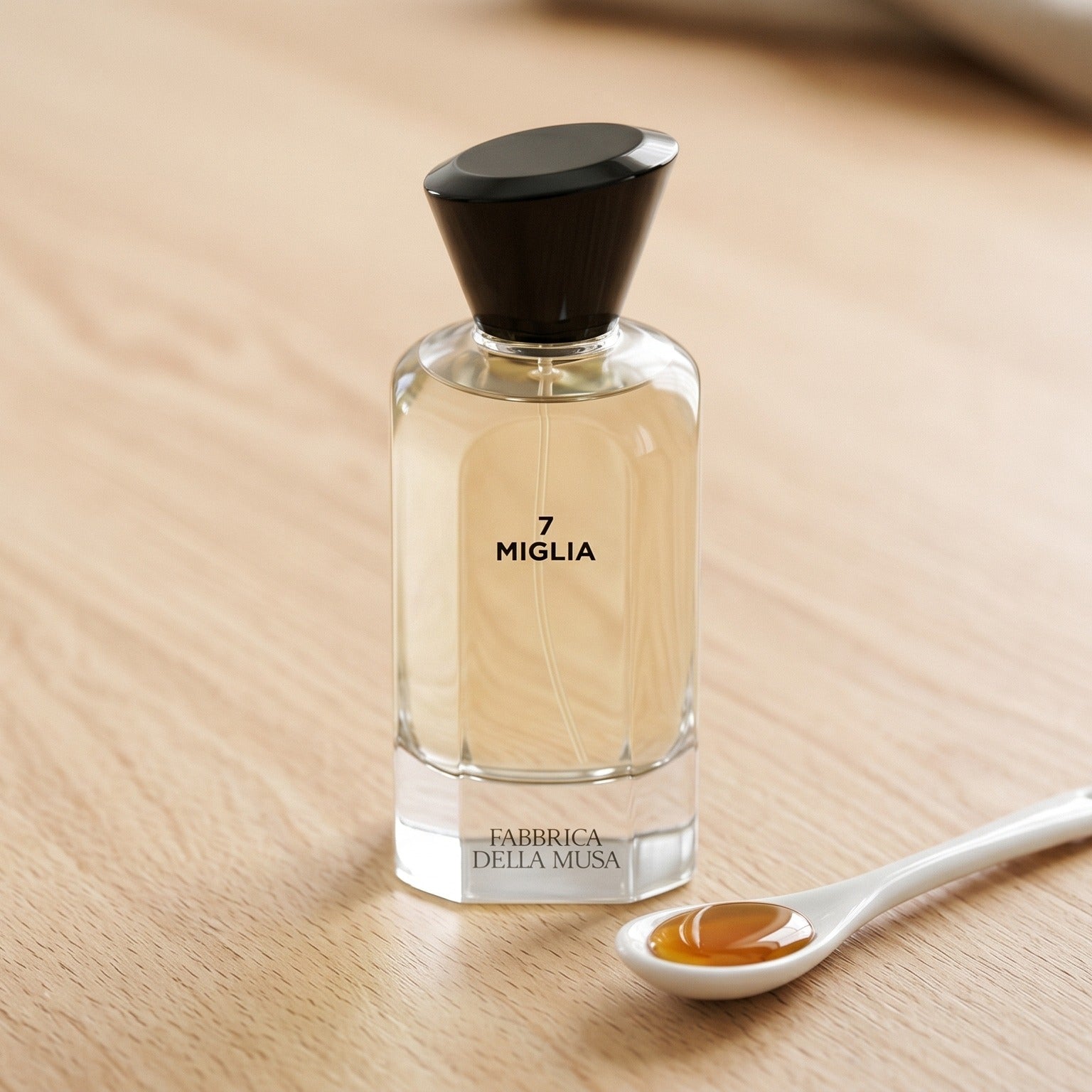 Fabbrica Della Musa Via Velluto EDP on pale maple with a tiny pitcher of maple syrup beside the bottle