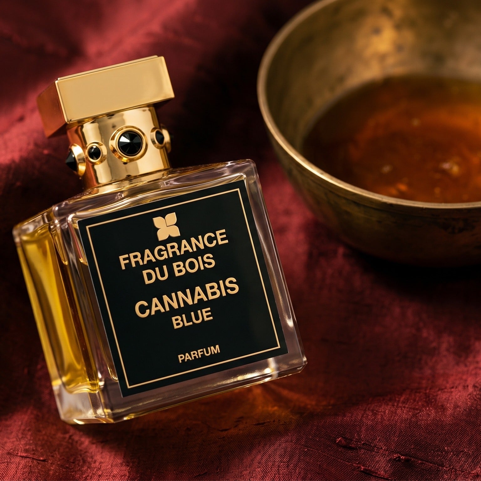 Fragrance du Bois Cannibis Blue on raw silk of oxblood color with a brass bowl of ambergris tincture