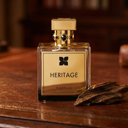 Fragrance du Bois Heritage Parfume on dark tan leather desk with a brass lamp casting a warm pool of light