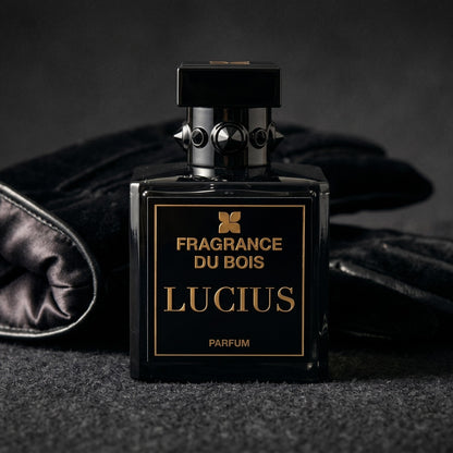Fragrance du Bois Lucius Parfum on charcoal felt with a silk-lined leather glove placed behind the bottle