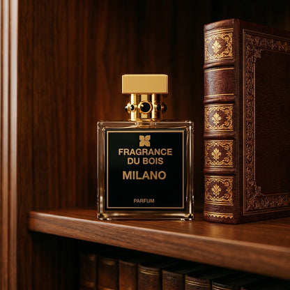 Fragrance du Bois Milano on ebony library table with a folded leather portfolio beneath it