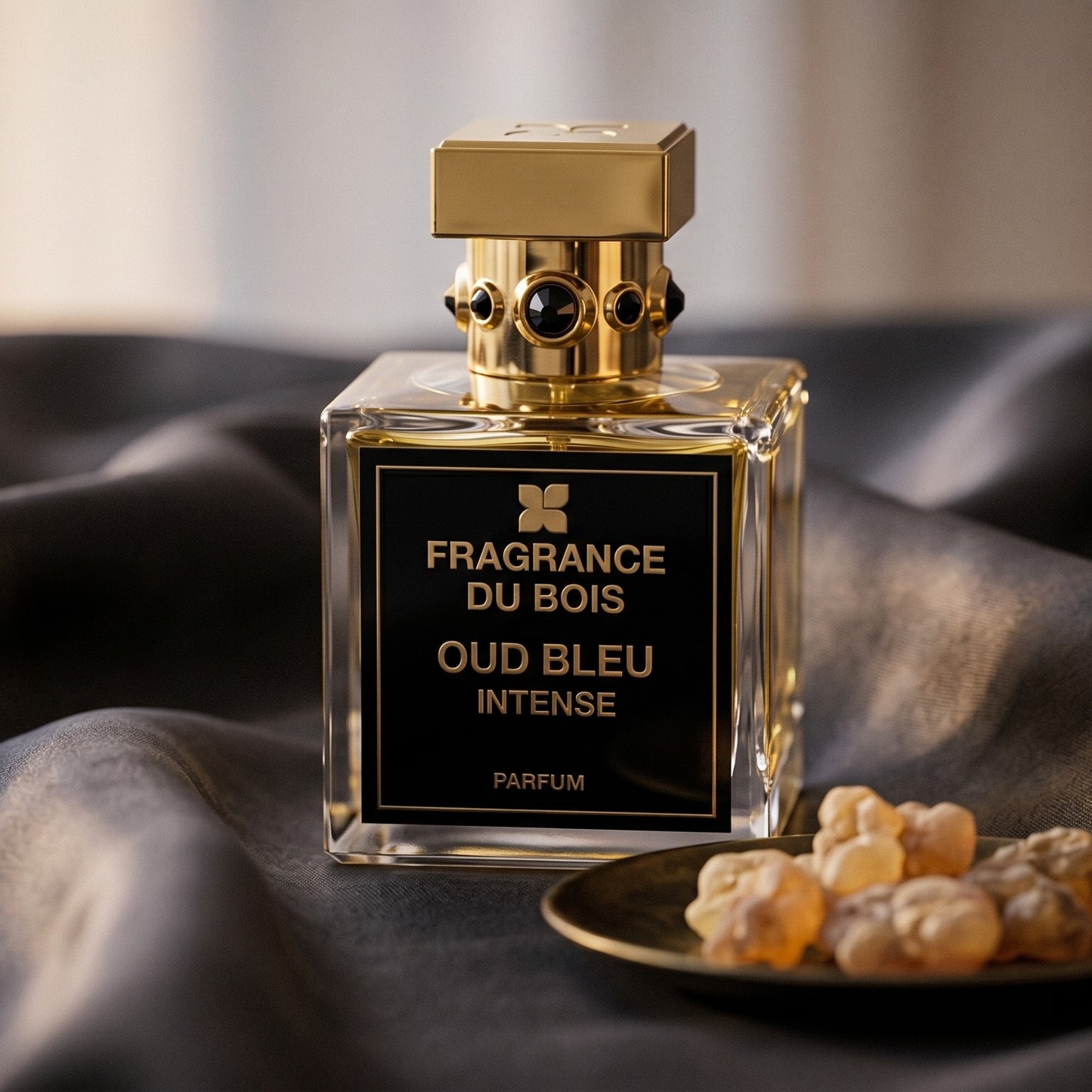Fragrance du Bois Oud Bleu Intense on deep indigo silk with a tiny copper bowl of myrrh pellets