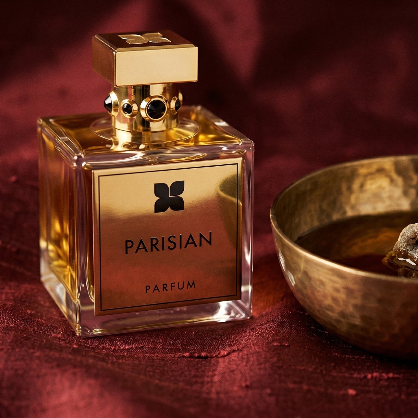 Fragrance du Bois Parisian Parfum EDP on raw silk of oxblood color with a brass bowl of ambergris tincture