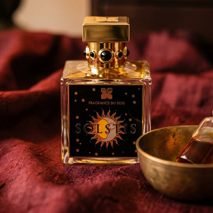 Fragrance du Bois Solstis on deep caramel velvet with a small copper jar of resin balm