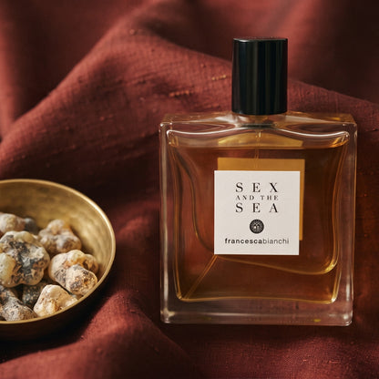 Francesca Bianchi Sex and the Sea EDP on raw silk of oxblood color with a brass bowl with ambergris tincture