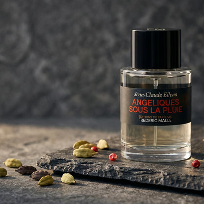 Frederic Malle Angeliques Sous La Pluie EDT on deep grey travertine with a scatter of nutmeg and allspice