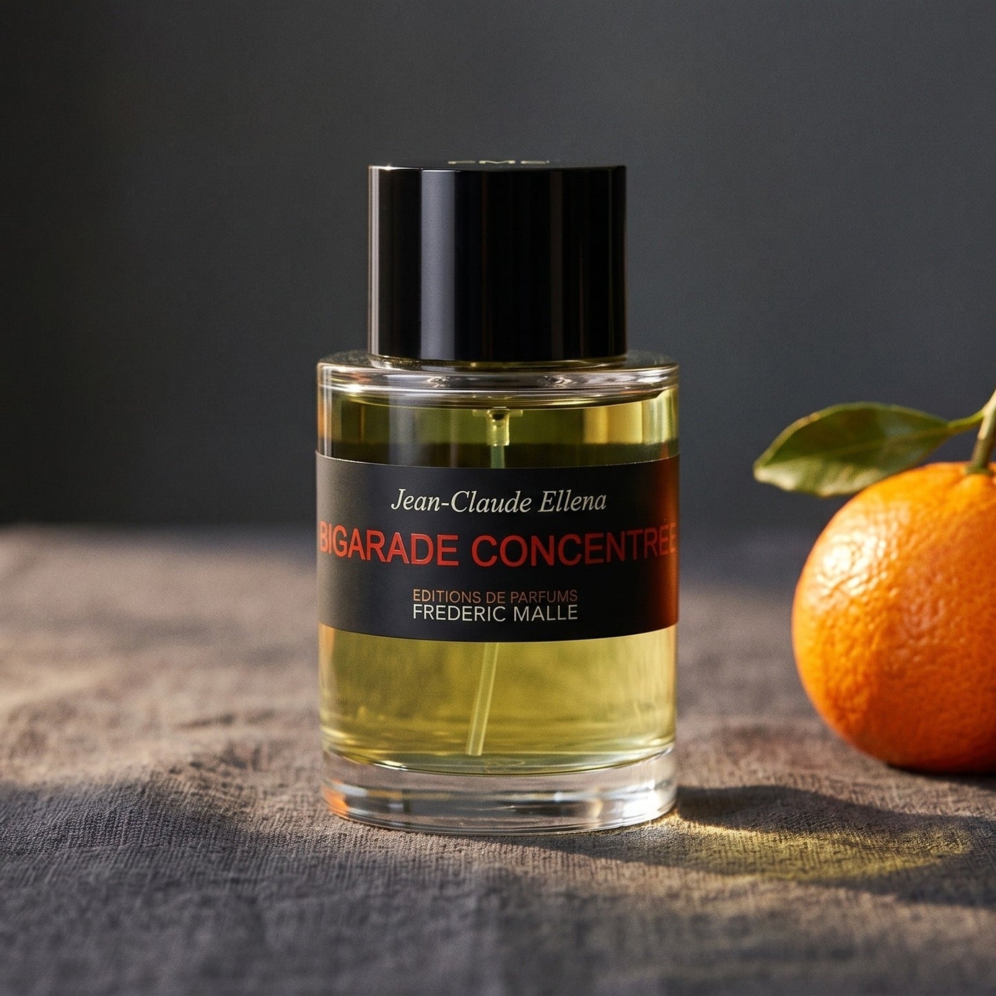 Frederic Malle Bigarade Concentree EDT on charcoal linen with a fresh mandarin