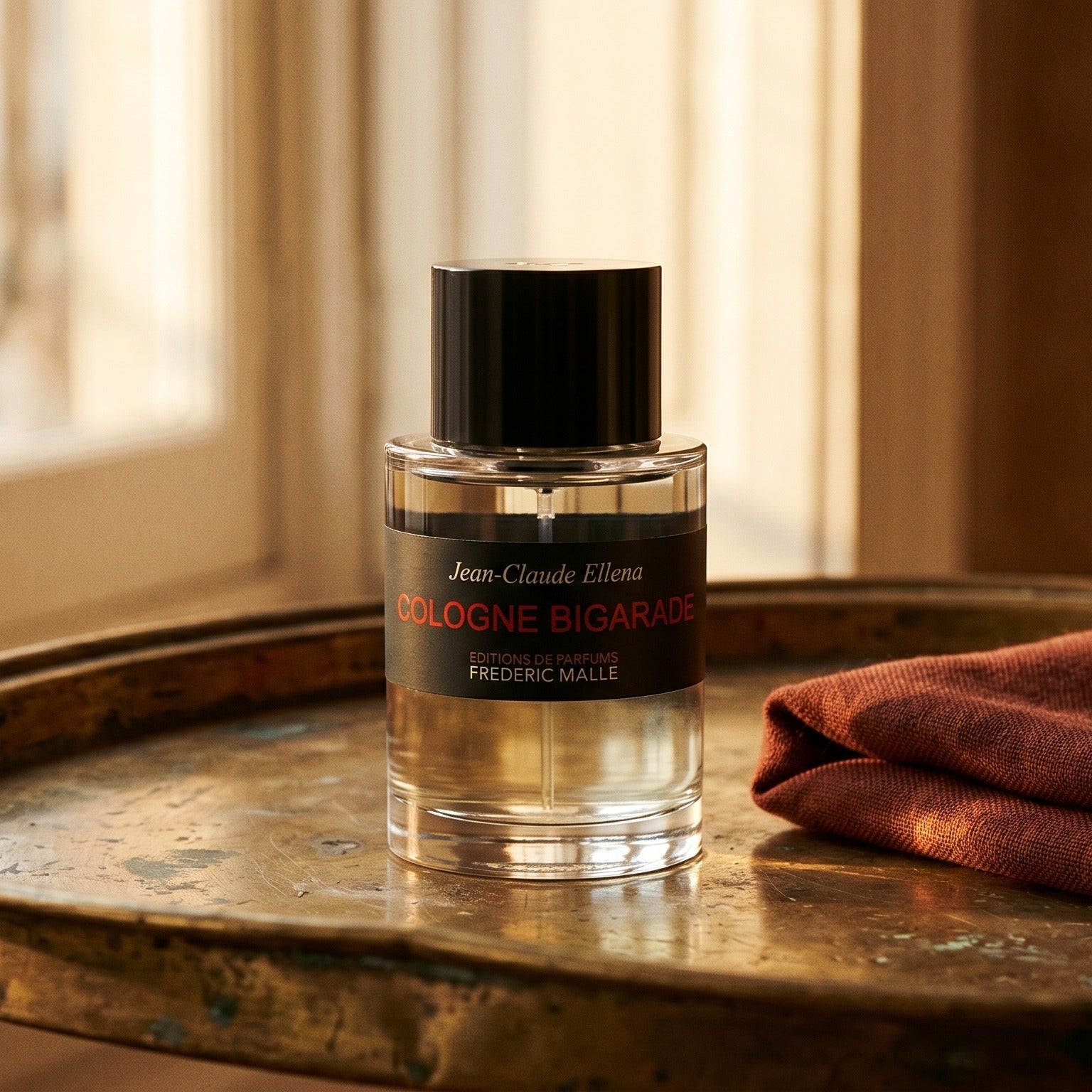Frederic Malle Cologne Bigarade EDC on tarnished silver platter with a merino throw in terracotta