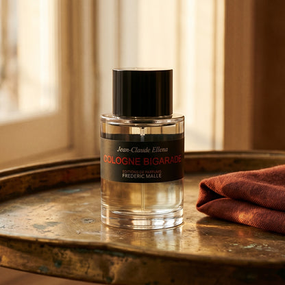 Frederic Malle Cologne Bigarade EDC on tarnished silver platter with a merino throw in terracotta