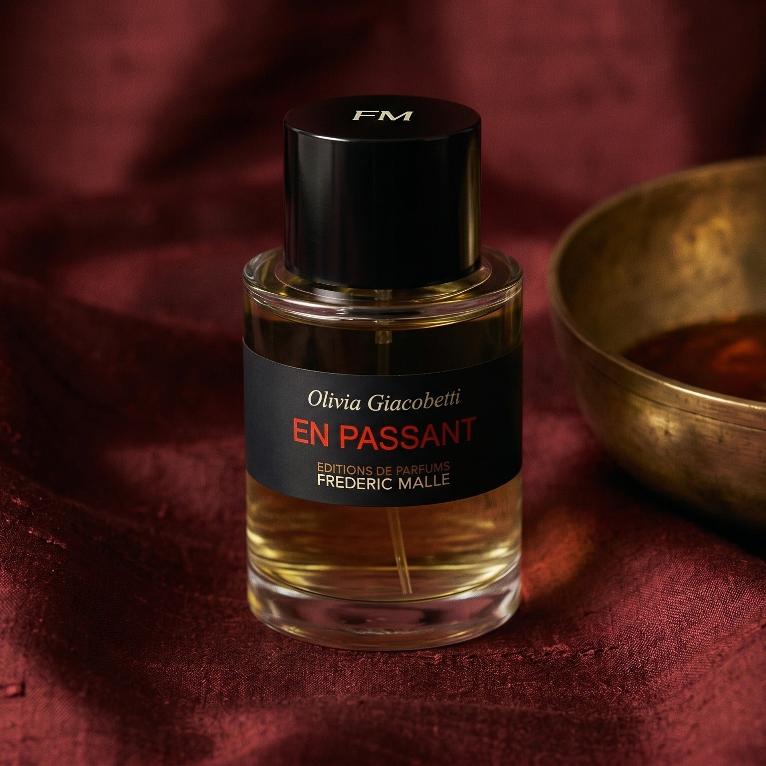 Frederic Malle En Passant EDP on raw silk of oxblood color with a brass bowl of ambergris tincture