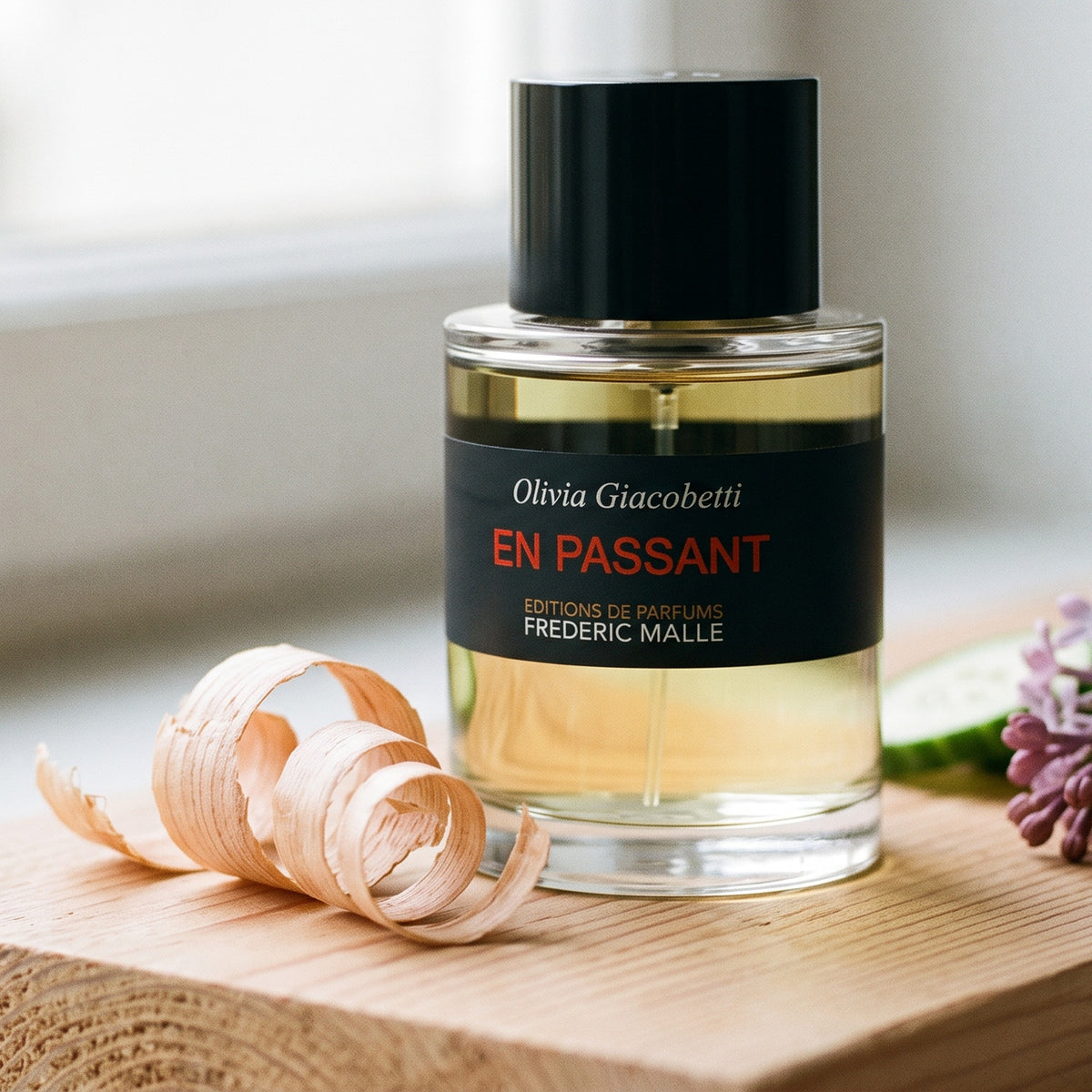 Frederic Malle En Passant EDP on light cedar board with a few curls of cedar shavings
