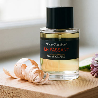 Frederic Malle En Passant EDP on light cedar board with a few curls of cedar shavings