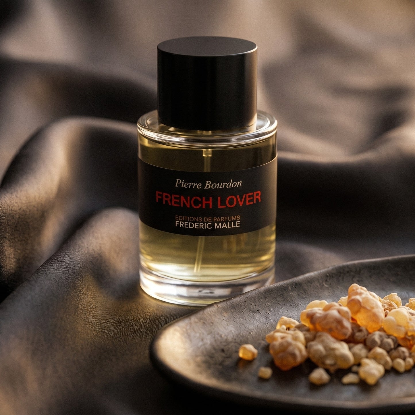 Frederic Malle French Lover EDP on onyx linen with dried rose petals and resin drops intermixed